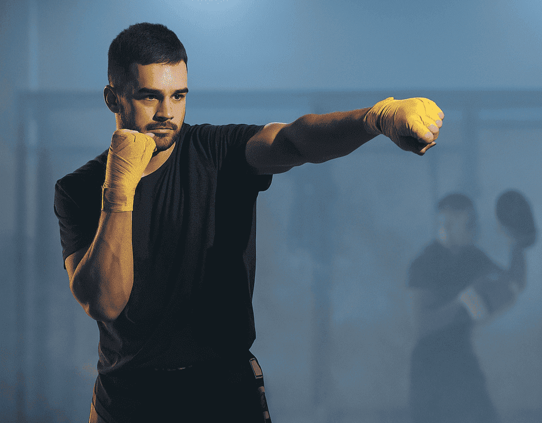 A man with boxing gloves practicing after drinking EliteCore protein shake.