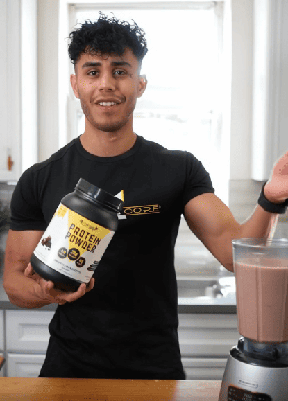 A man using a blender to make a healthy chocolate smoothie using EliteCore Chocolate Protein Powder with added BCAAs for muscle growth and recovery.