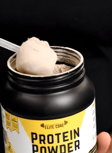 Protein powder container with a scoop of whey isolate protein powder.
